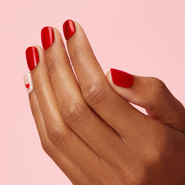 If her love language is gifts... Add to cart immediately. Short length, square shape, glossy finish. True red and sheer nude press-on gel nails featuring red hearts, polka dots, and red glitter.