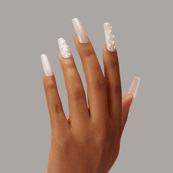 Semi-sheer, milky white glue-on gel nails featuring 3D pearl accents & iridescent glitter.