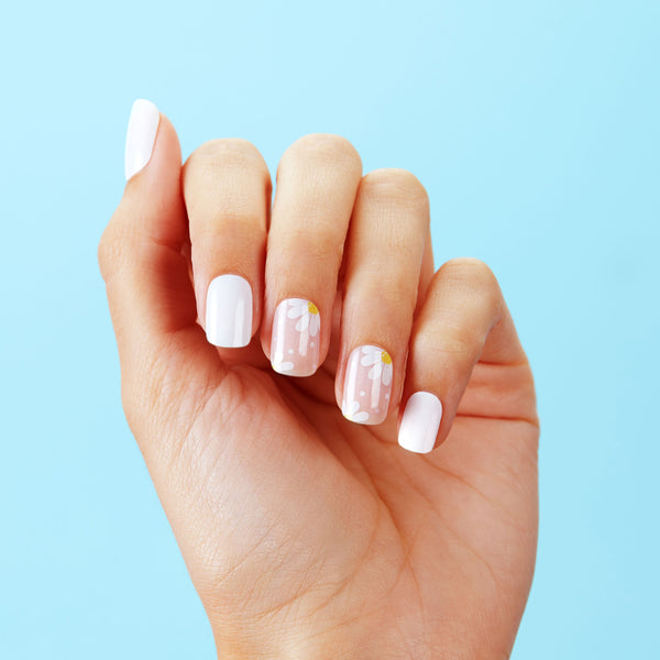 Semi-cured white & nude gel nail strips featuring daisy accents with mega volume & maximum shine.