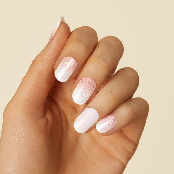 Sheer nude gel nail strips featuring 3D pearl accents and a magnetic finish with a double gel formula for an ultra smooth finish.