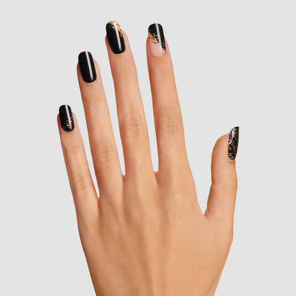 Semi-cured black gel nail strips featuring iridescent glitter, iridescent mosaic accents, and asymmetrical french tips with mega volume and maximum shine.
