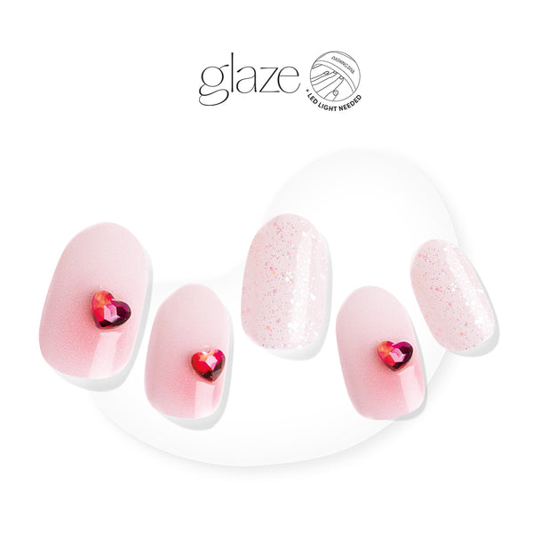 Glam even when you're going through it. Semi-cured nude pink gel nail strips featuring iridescent glitter, heart-shaped gems, and red ombré accents with mega volume and maximum shine. 