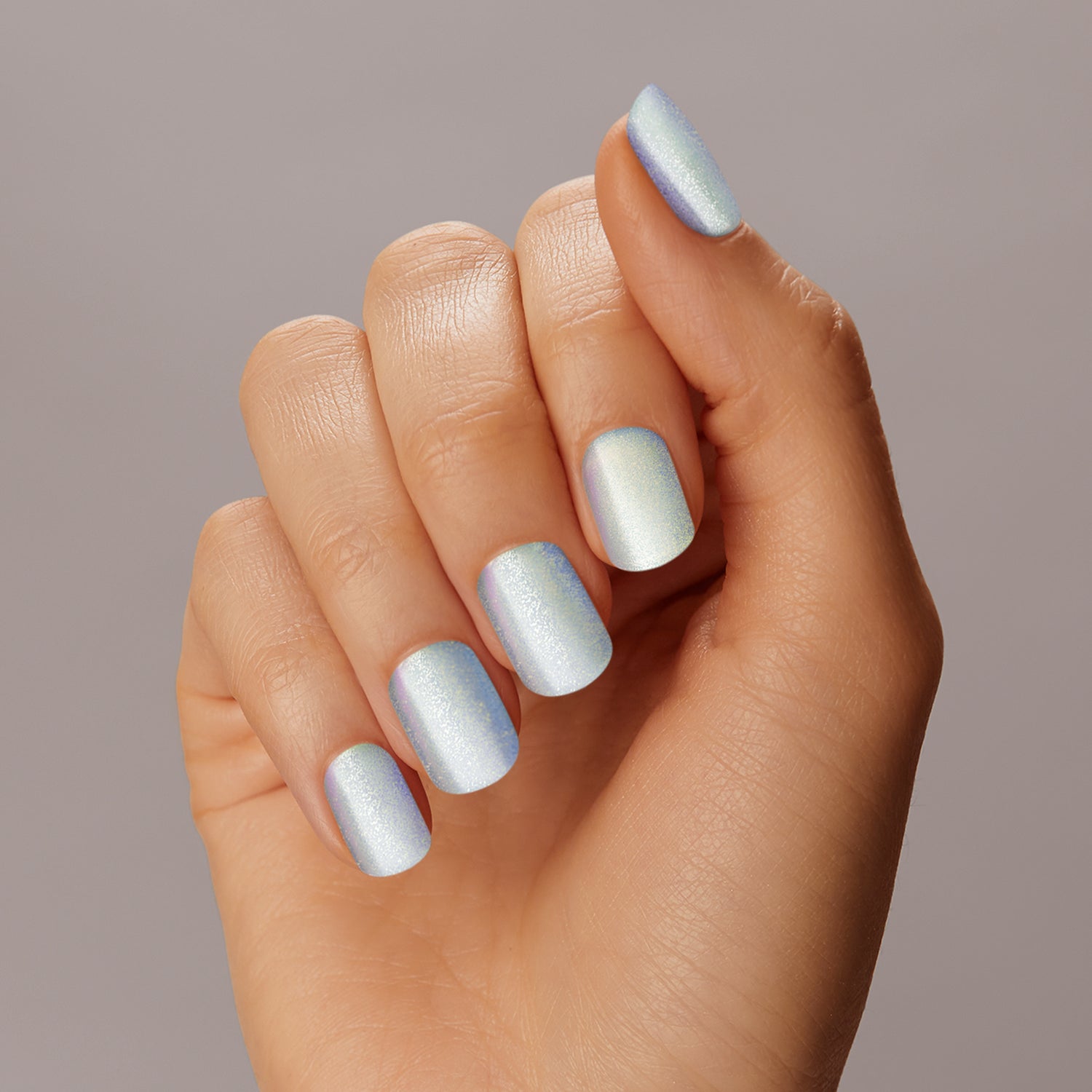 Can you feel it? Semi-cured ice blue gel nail strips featuring velvet shimmer and iridescent chrome effects with mega volume and maximum shine.