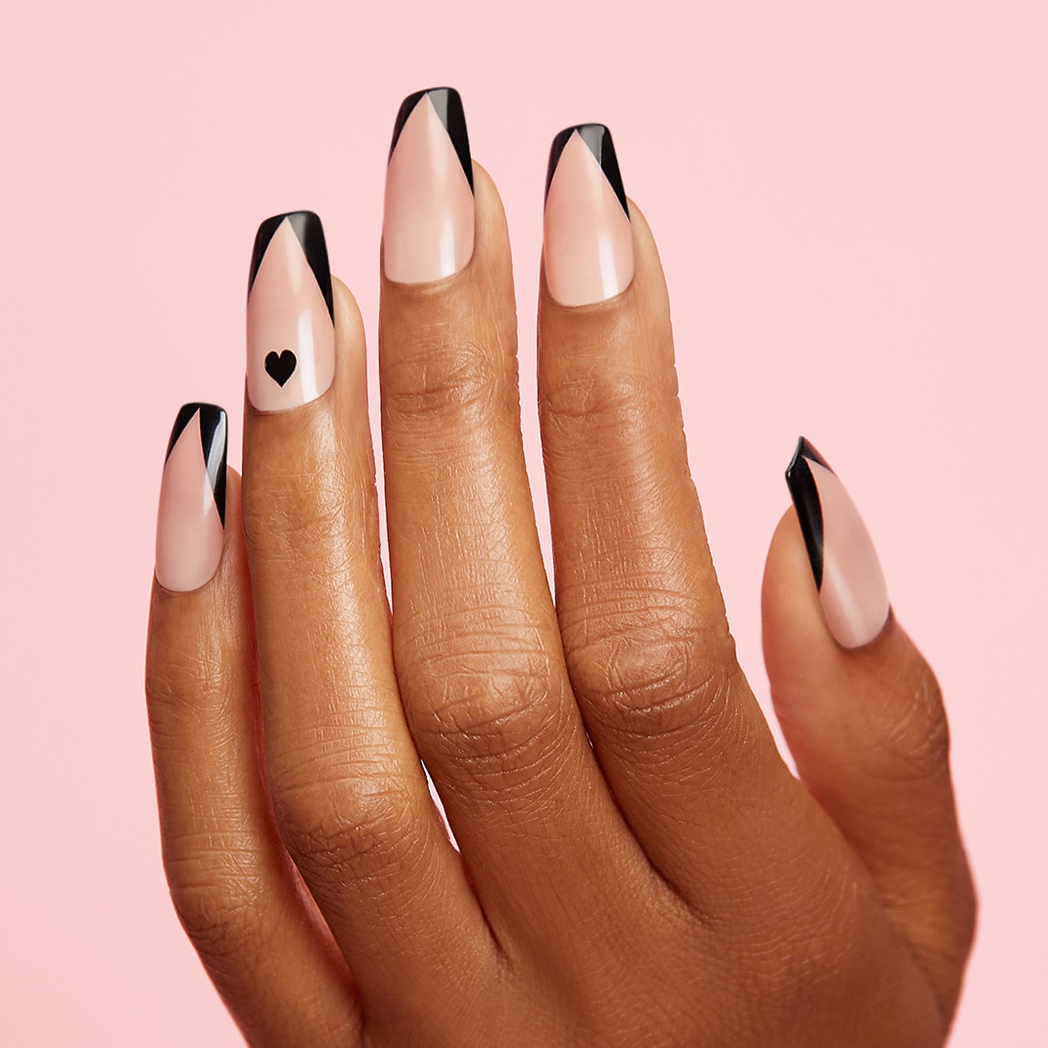 Lover boys love picking out your next mani. Long length, square shape, glossy finish. Sheer nude glue-on gel nails featyuring black hearts and black chevron french tips.