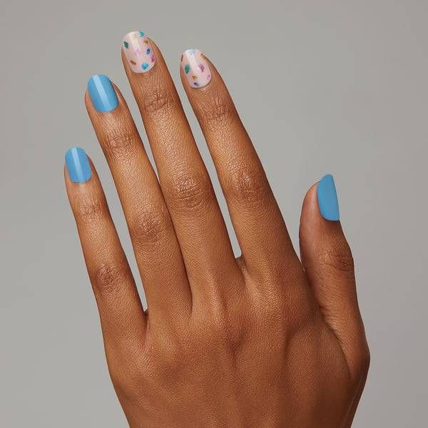 Now you see them, now you don't... Bright blue & nude pink gel nail strips featuring multicolor mosaic accents with a glossy, high-shine finish. 