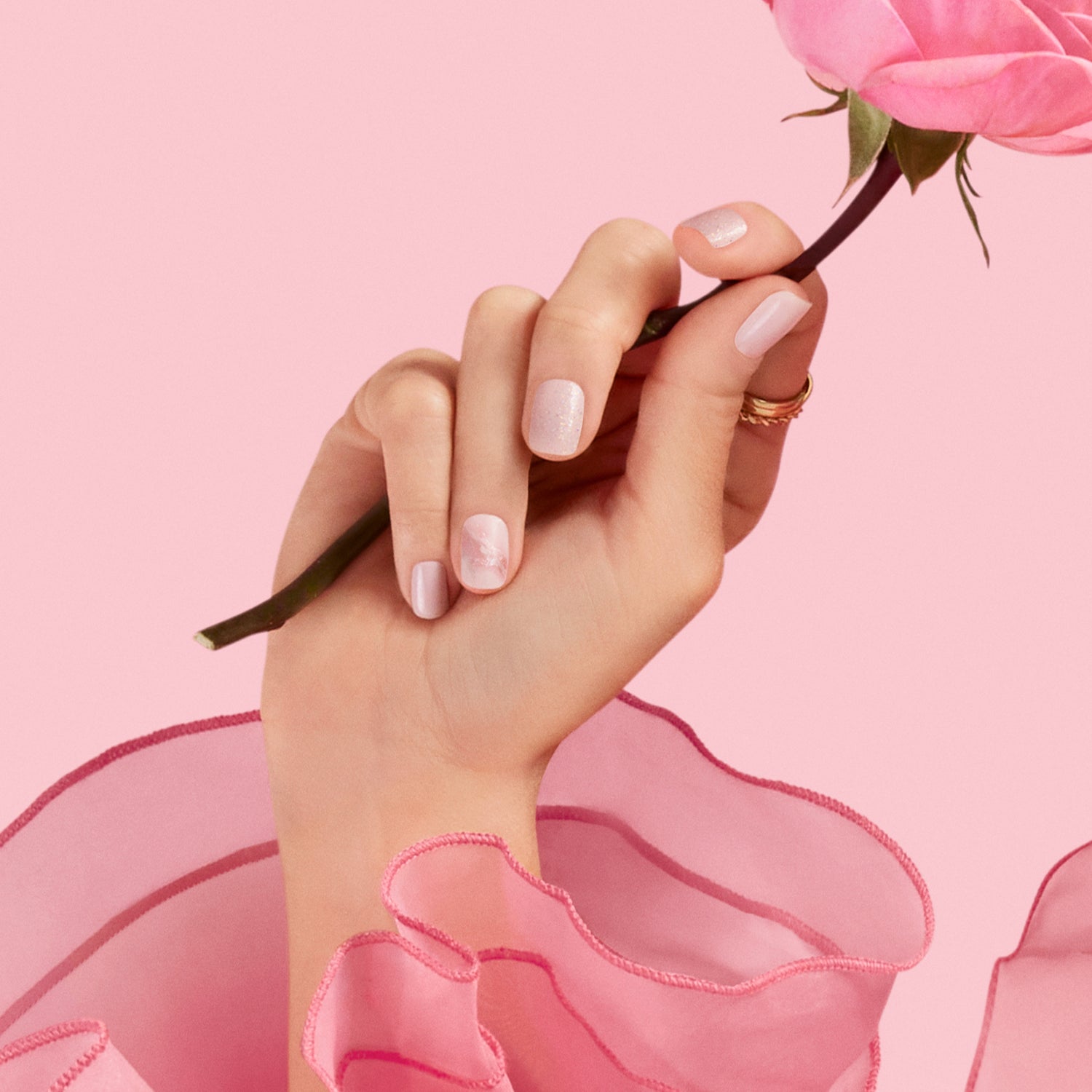 Marble *may be* your best look yet… Light pink gel nail strips featuring iridescent glitter and marble accents with a glossy, high-shine finish.
