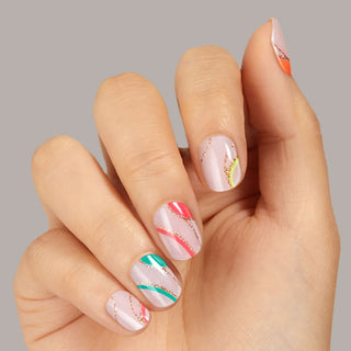 Sheer, nude pink gel nail strips featuring neon, multicolor swirls & gold glitter with mega volume and maximum shine.