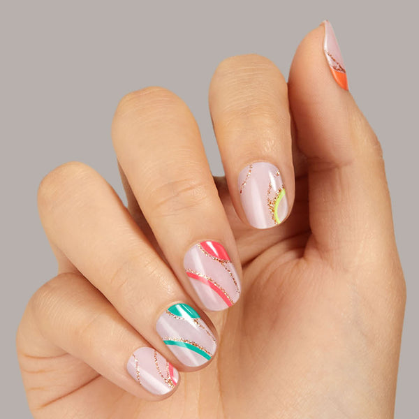 Sheer, nude pink gel nail strips featuring neon, multicolor swirls & gold glitter with mega volume and maximum shine.