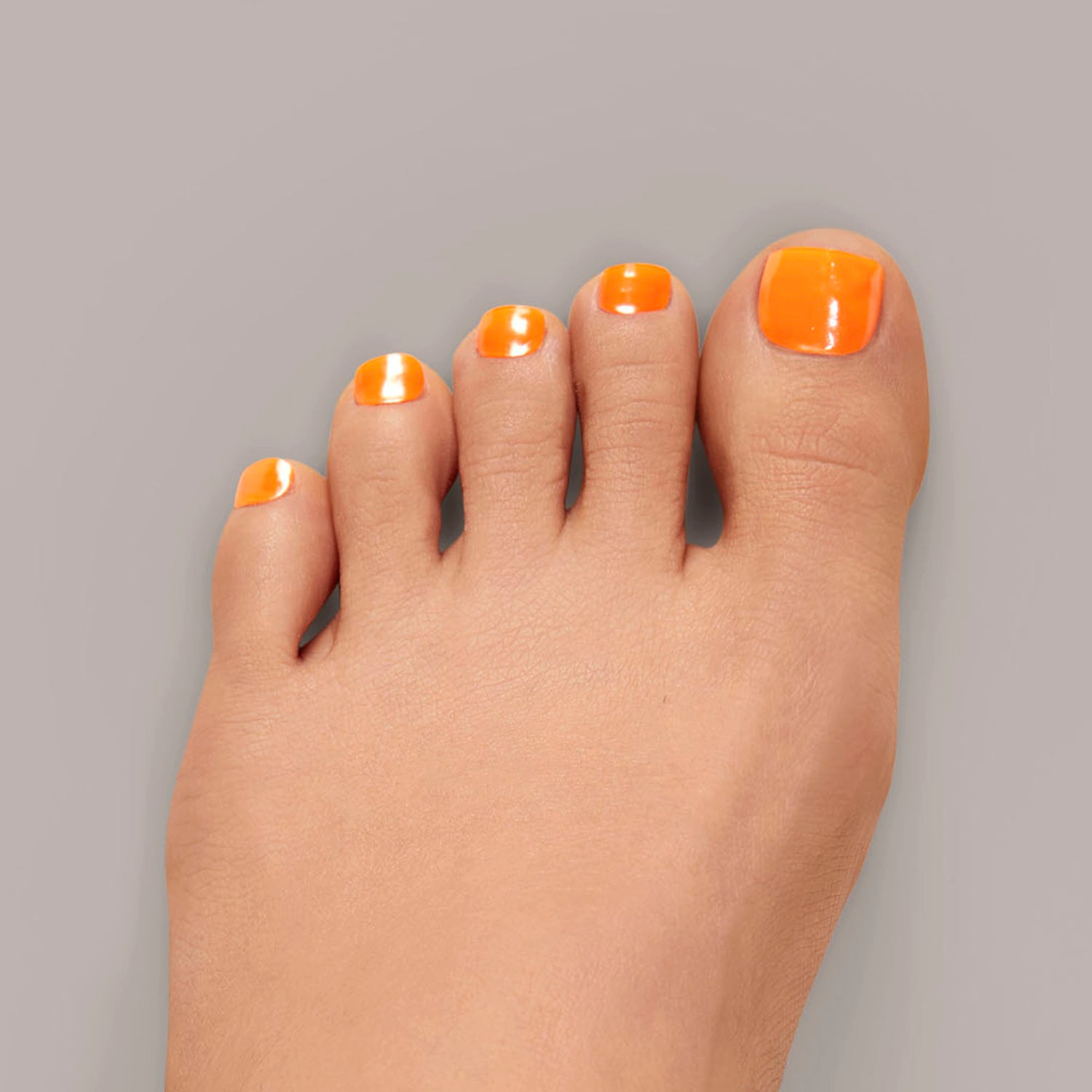 Semi-cured neon orange gel pedicure strips featuring a shimmery chrome finish 