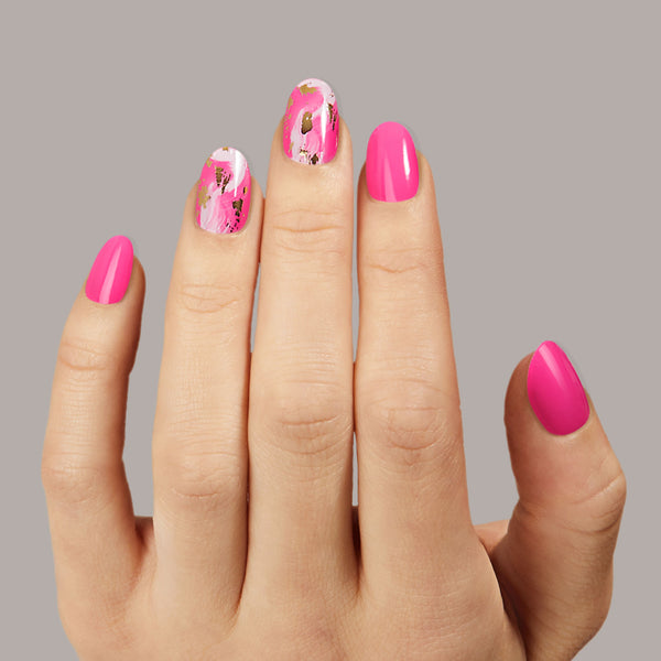 Neon pink nail strips featuring gold foil and paint brushed accents