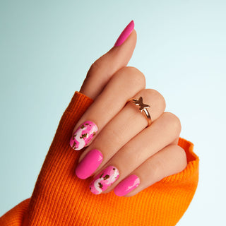 Neon pink nail strips featuring gold foil and paint brushed accents