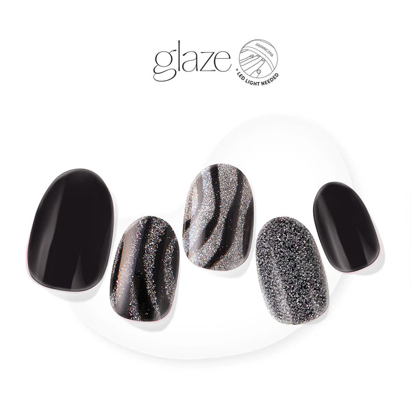 Semi-cured black gel nail strips featuring silver glitter with mega volume & maximum shine.