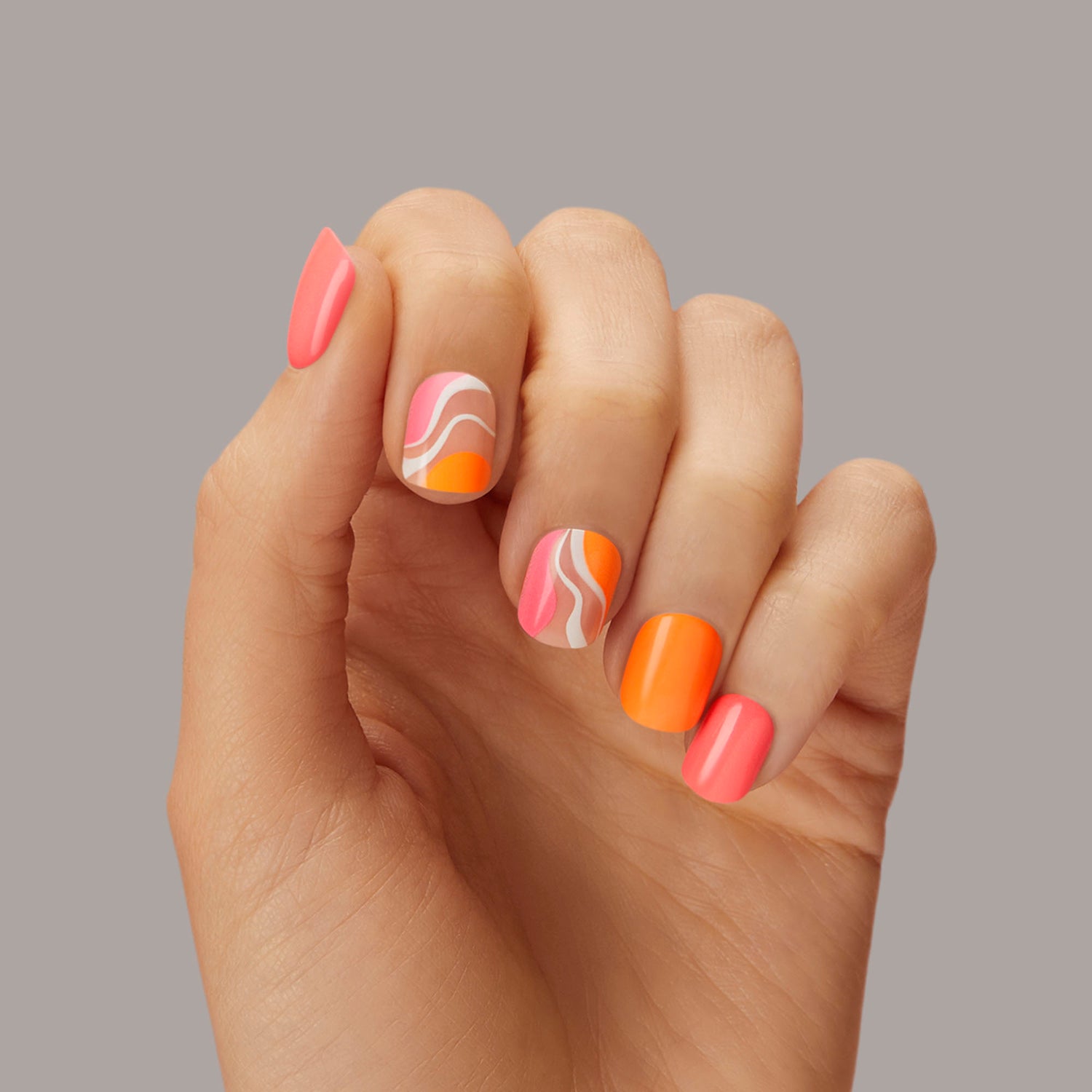 Medium length, square shape, glossy finish. Neon pink, orange, and sheer nude press-on gel nails 