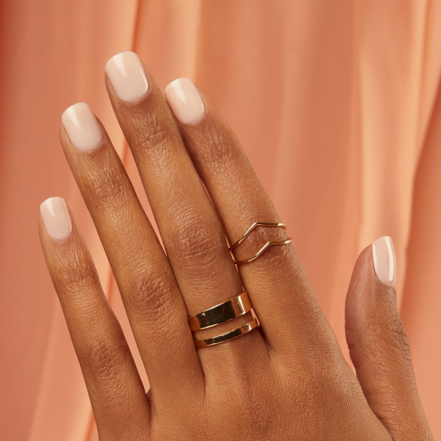 Short length, square shape, glossy finish. Cream press-on gel nails featuring a subtle ombré with a clear base.