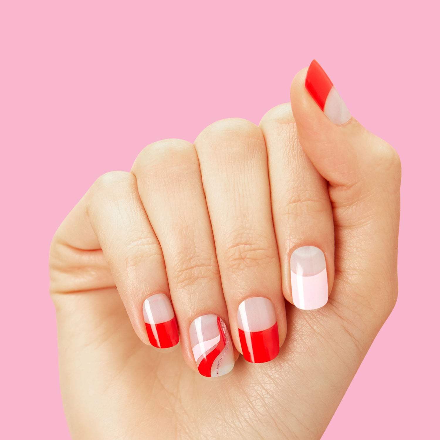 red, and pink French tips, and pink and red swirls with gold accents
