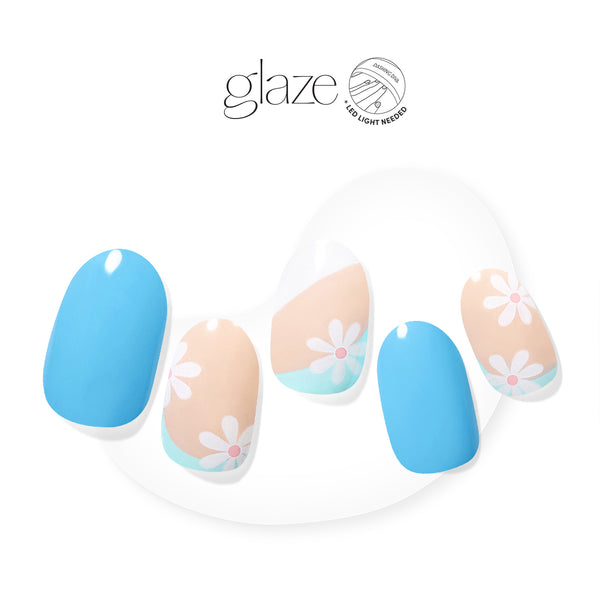  Semi-cured bright blue & nude gel nail strips featuring abstract color blocking and daisy accents with mega volume & maximum shine.