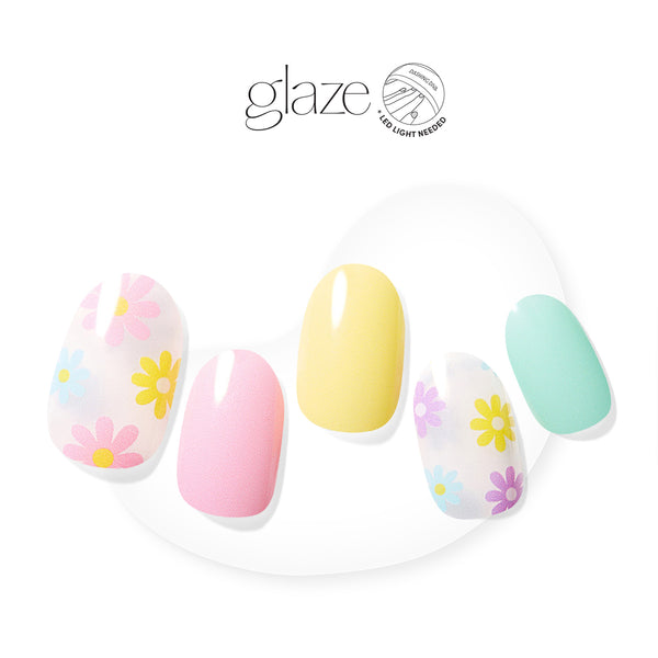  Semi-cured pink, yellow, and turquoise gel nail strips featuring daisy accents with mega volume & maximum shine. 