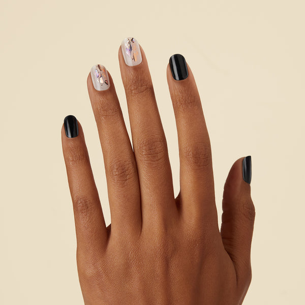 Semi-cured black & milky white gel nail strips featuring rose gold foil and mosaic accents with mega volume & maximum shine.