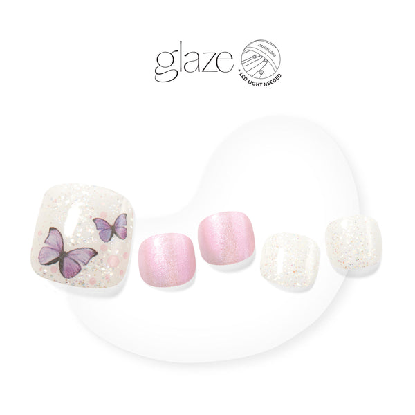Dashing Diva GLAZE semi-cured white gel pedicure strips with confetti glitter and butterfly accents.