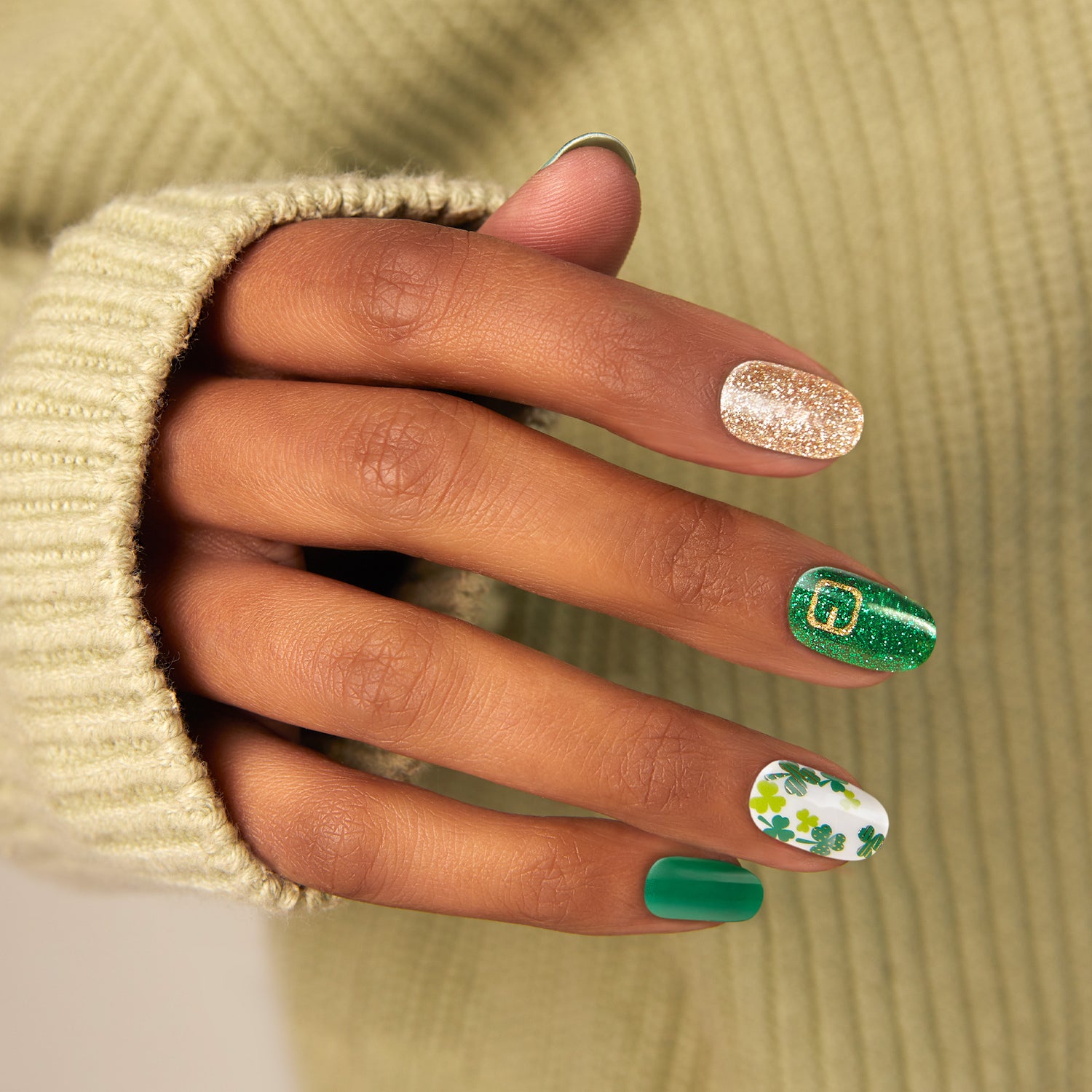 Shamrock green nail strips featuring green four-leaf clovers, gold glitter, and belt buckle accents with a glossy, high-shine finish.
