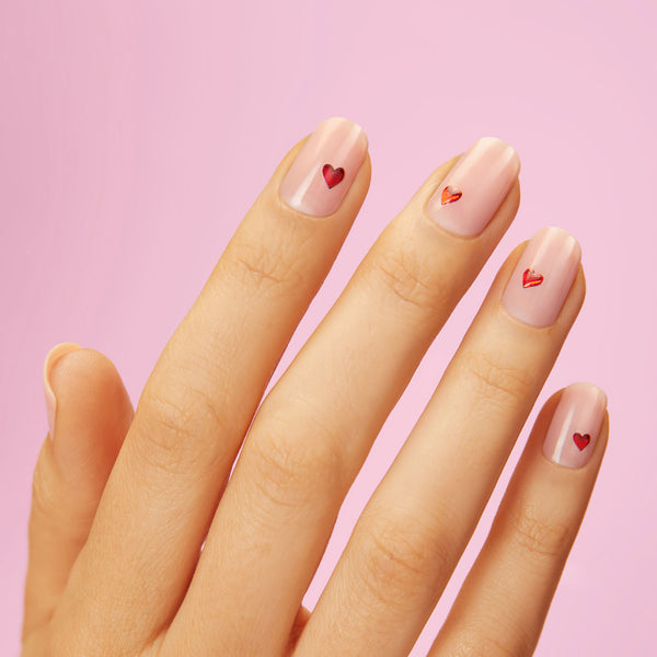 Pink nail strips featuring a dainty heart design 
