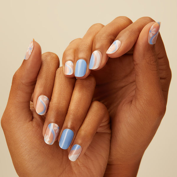 Sky blue gel nail strips featuring white and blue swirls, and floral accents