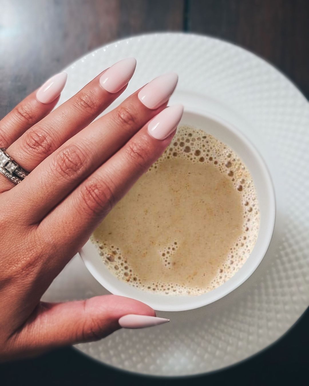 Long length, stiletto shape, glossy finish nude press-on gel  WITH A COFFEE