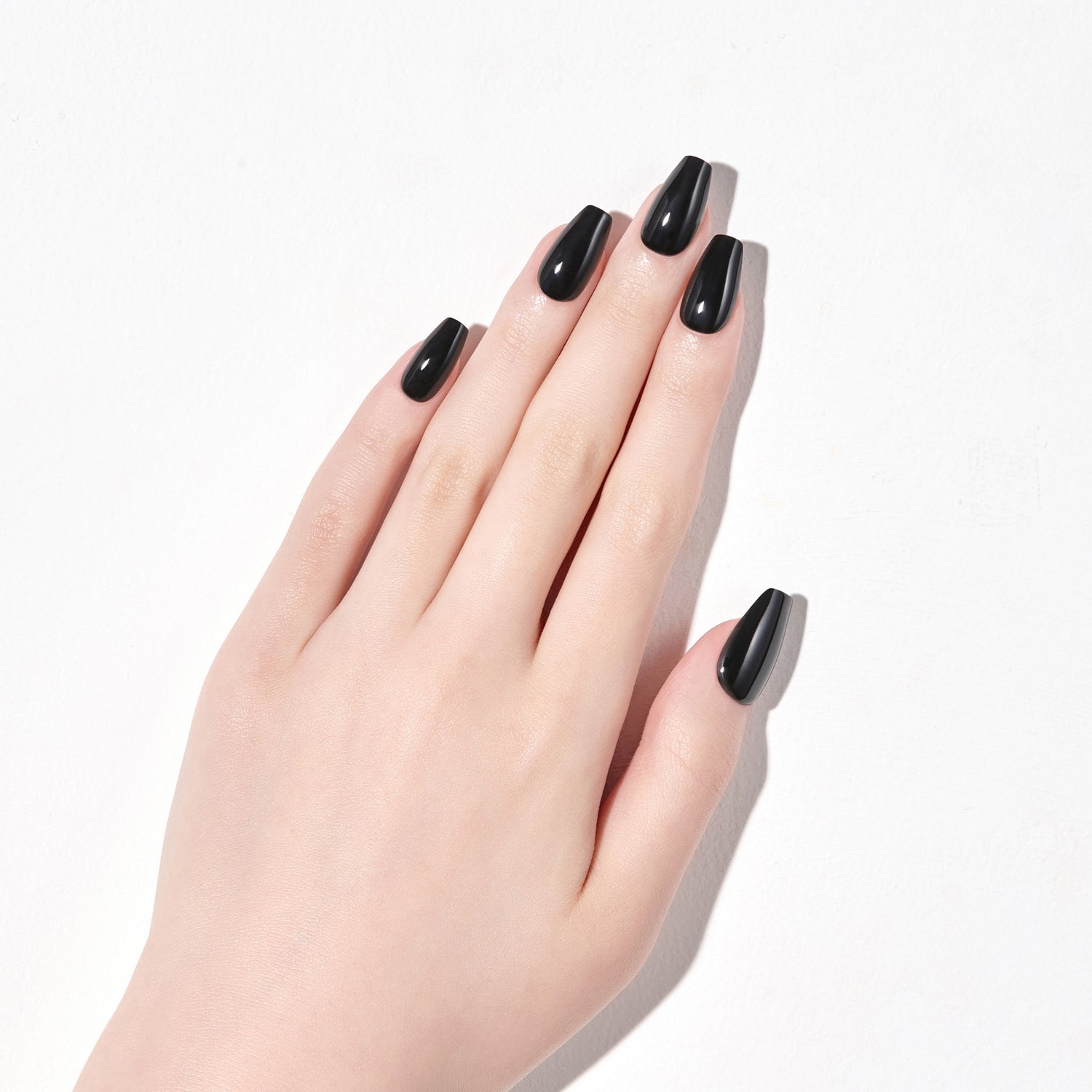 Long length, coffin shape, glossy finish press-on gel nails.