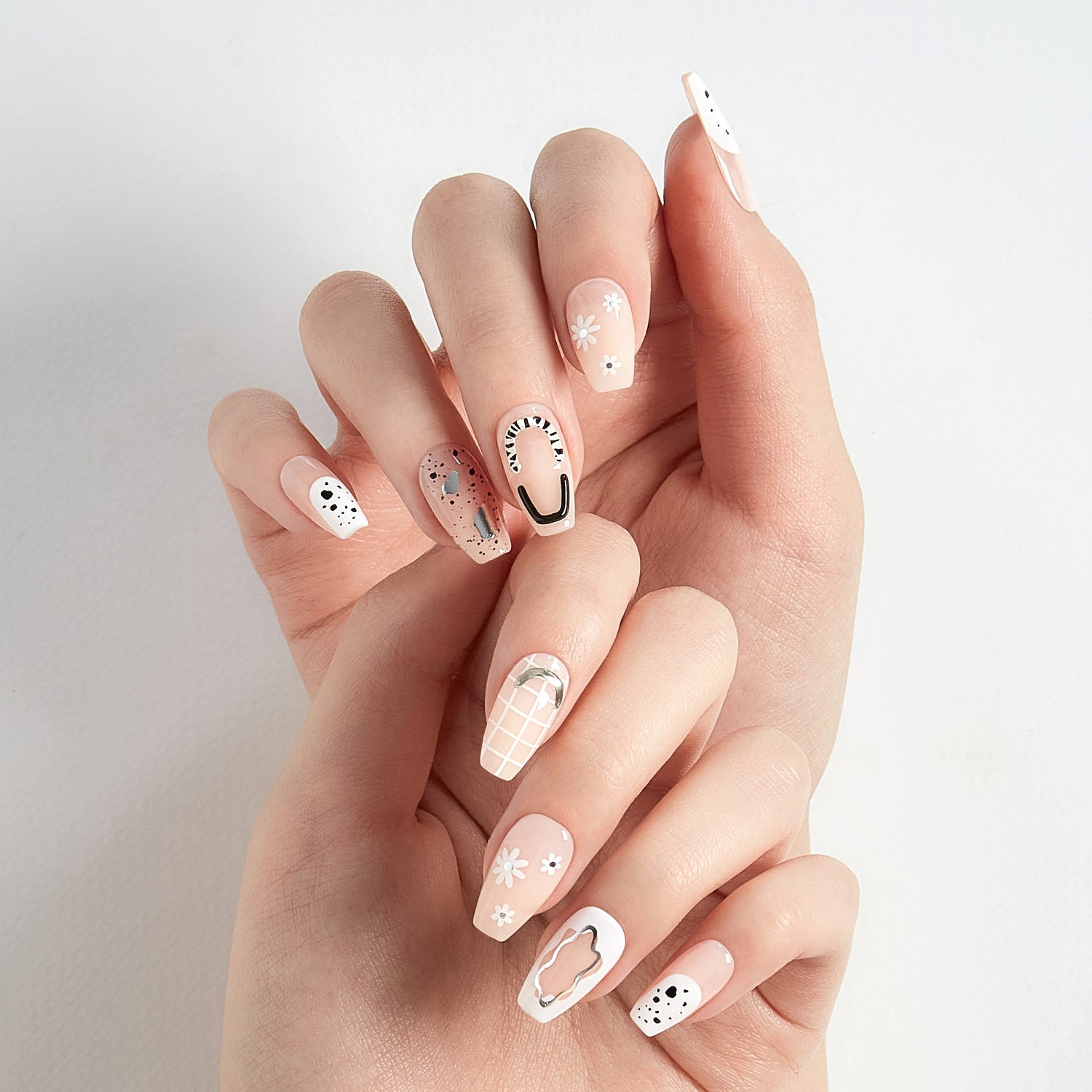 Long length, coffin shape, glossy finish sheer nude press-on gel nails featuring 3D abstract art accents.