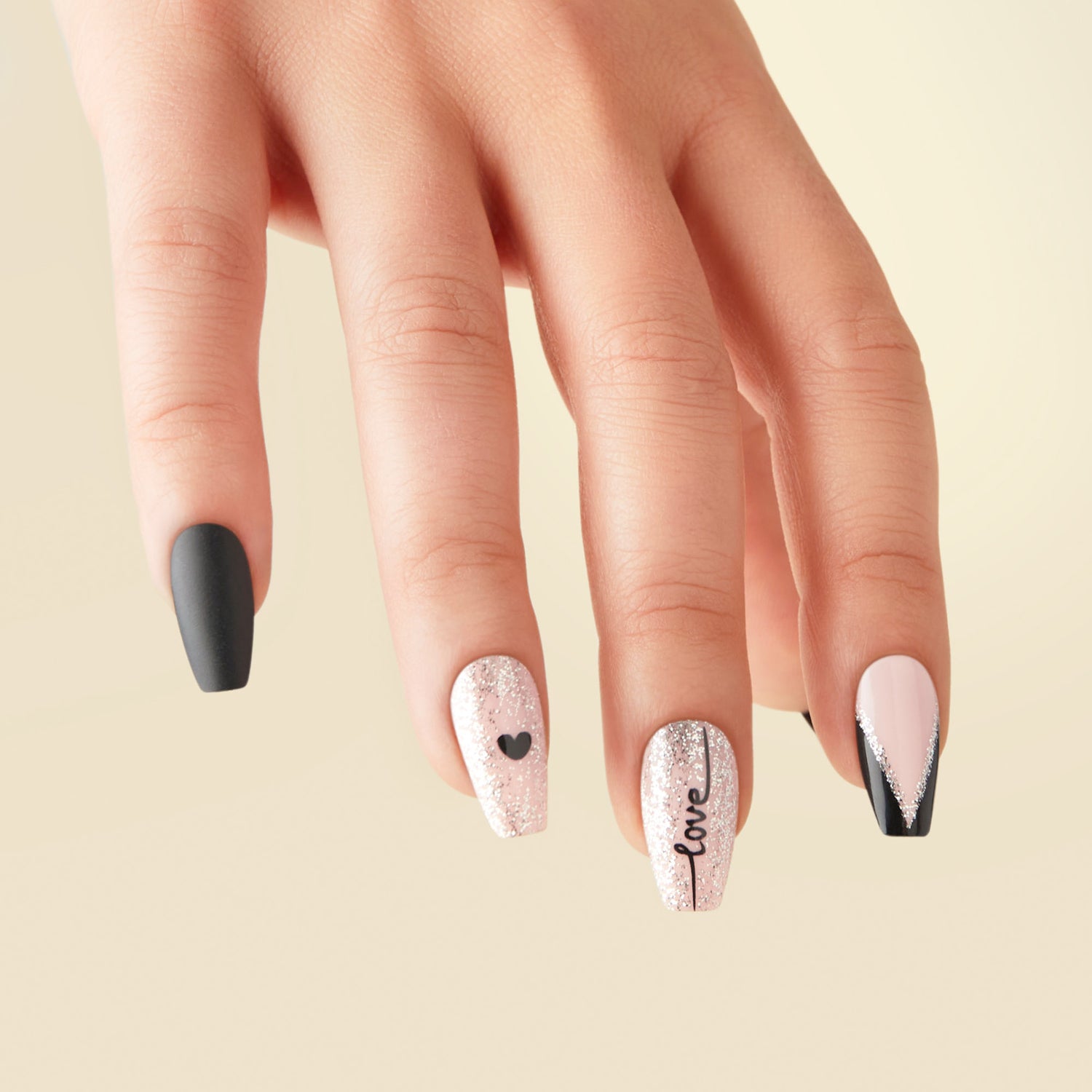 Long length, coffin shape, glossy finish black, and nude press-on nails. Featuring silver glitter and cursive love letters