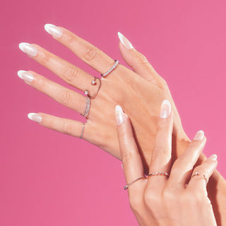 White french tip press-on gel nails featuring, medium length, almond shape, and a shimmery chrome finish. 