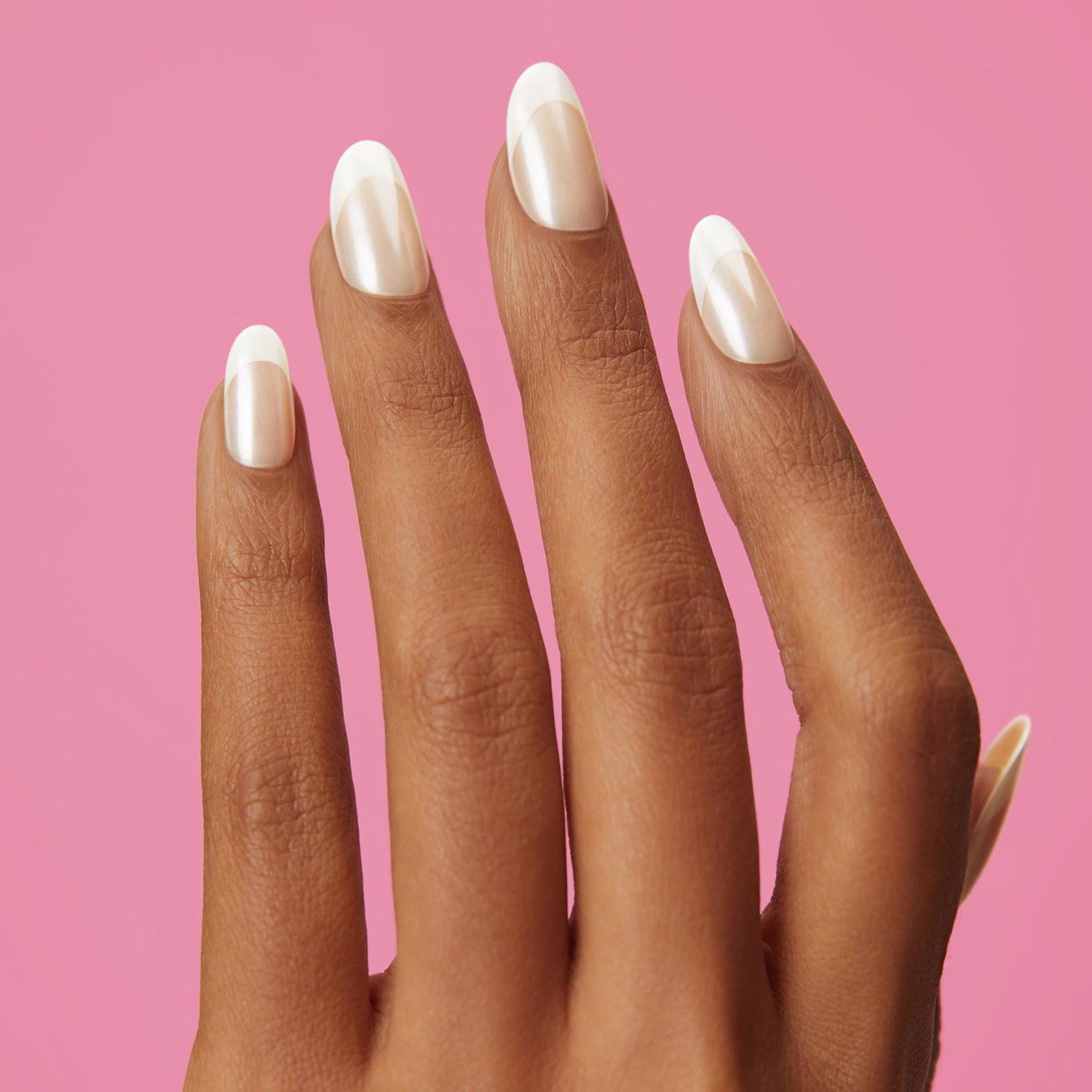 White french tip press-on gel nails featuring, medium length, almond shape, and a shimmery chrome finish. 