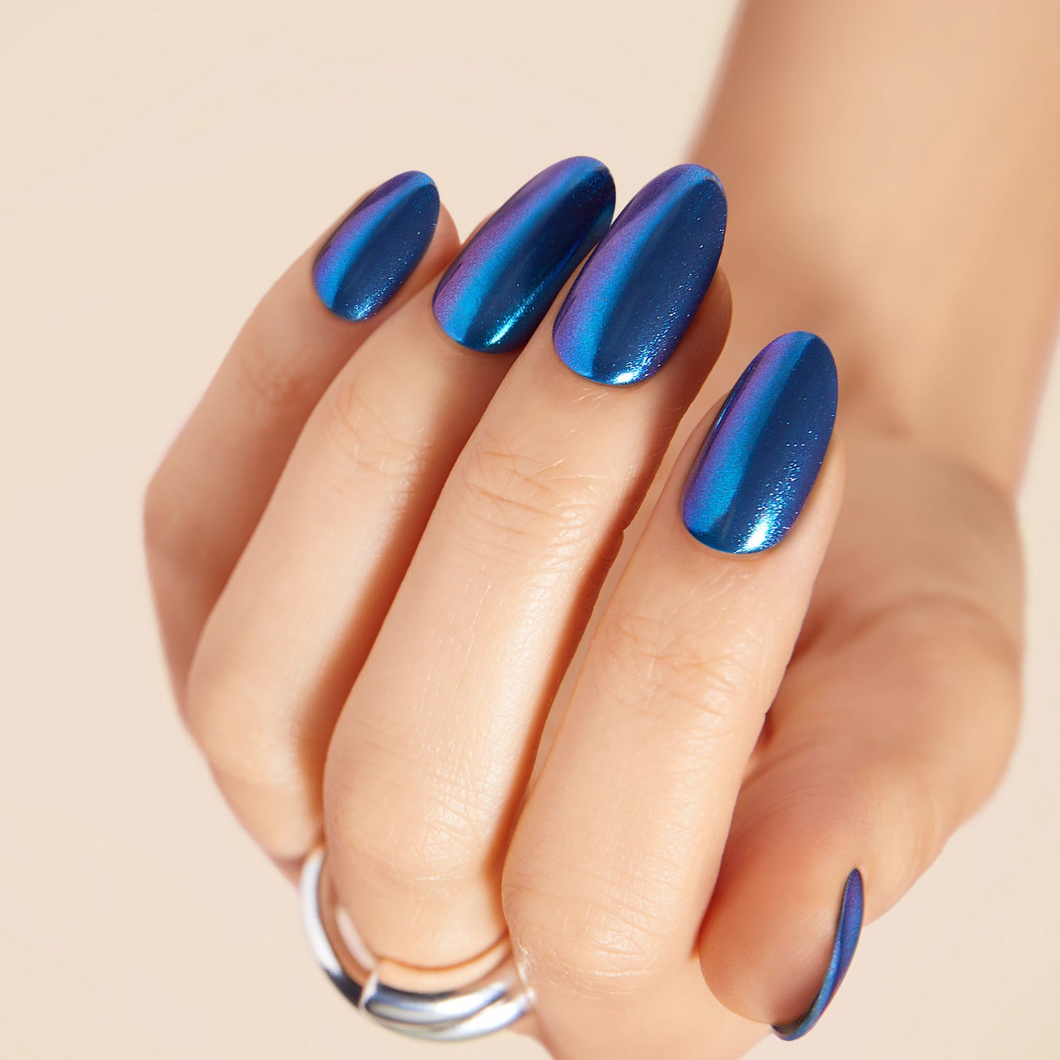  Reflective blue press-on gel nails featuring a medium-length, almond shape, with a metallic chrome finish.