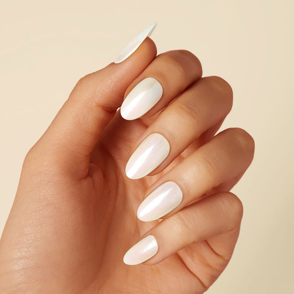 Off-white pearlescent press-on gel nails featuring, medium length, almond shape, and a metallic chrome finish.